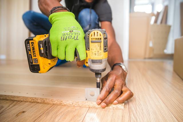 a worker using a push pull screwdriver on the floor