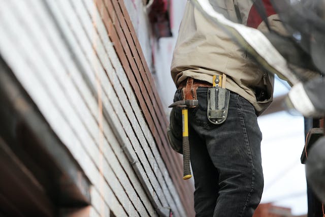 worker with many tools around his waist