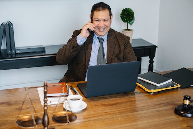 Person sitting at a desk in a legal office and making a call